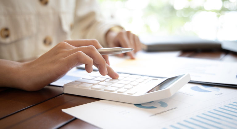 Accounting businesswomen are calculating income-expenditure and analyzing real estate investment data, Dedicated to the progress and growth of the company, Financial and tax systems concept.